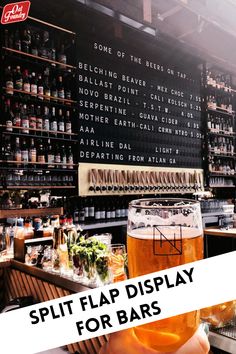 a person holding up a beer in front of a bar