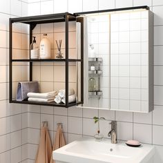 a bathroom with a sink, mirror and shelf above the toiletries on the wall