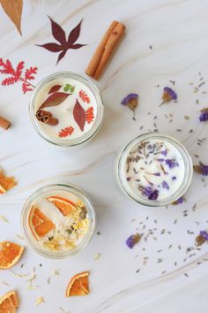 three small glass jars filled with different types of food and spices on top of a table