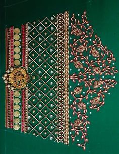 a piece of cloth that has been decorated with gold and red bead work on it