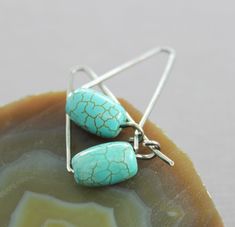 "These elegant and minimalist earrings made with hand forged 18 gauge sterling silver wire accented with beautiful barrel shape turquoise stone (11mm by 7mm in size) and were tumbled, oxidized and hand polished for antique finish patina. The earrings are approximately 1\" (2.5cm) long in total. ATTENTION - ORDERS TO US: Shipping to US uses USPS First Class shipping option. Delivery standard time 2-3 business days with USPS Tracking number. USPS Priority Shipping can be selected on checkout for a Minimalist Turquoise Wire Wrapped Earrings, Earring Inspiration, Silver Ear Cuff, Earrings Geometric, Earrings Inspiration, Earrings Simple, Earrings Minimalist, Threader Earrings, Simple Earrings