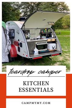 a camper trailer with the words kitchen essentials in front of it and an image of