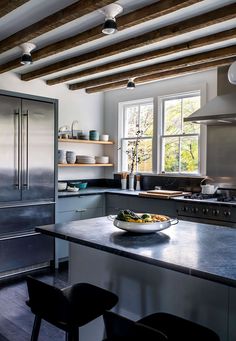 a bowl of food is on the counter in this modern kitchen with stainless steel appliances