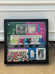 a black frame with magazines and beads on the floor