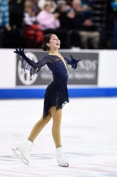 a female figure skating on an ice rink