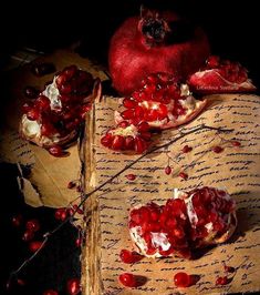 the pomegranates are on top of an old piece of paper