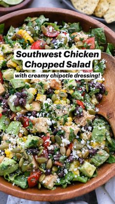 southwest chicken chopped salad with creamy chipotie dressing in a wooden bowl on a table