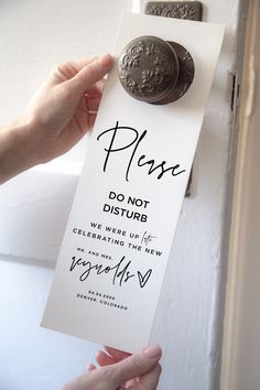 a person holding up a sign that says please do not disturb