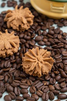 three pieces of chocolate sitting on top of coffee beans