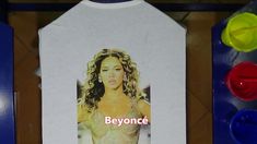 a white t - shirt with a picture of a woman on it