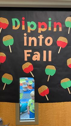 a bulletin board that says dippin'into fall with popsicles on it and an image of a baby in the background