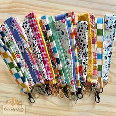 a bunch of different colored dog leashes lined up on top of each other in rows