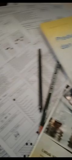 a desk with papers and pens on it