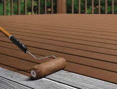 a paint roller on top of a wooden deck