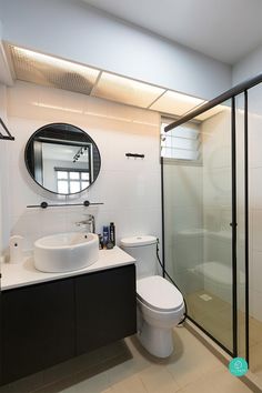 a bathroom with a toilet, sink and shower stall