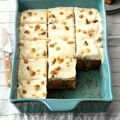 a blue dish filled with carrot cake and frosting