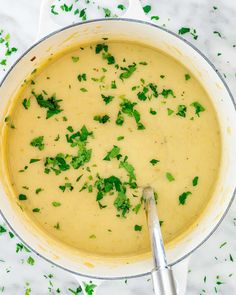 a pot filled with soup and garnished with parsley