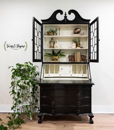 an old fashioned china cabinet with plants in it