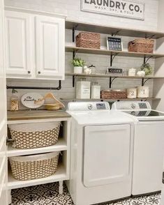 a washer and dryer in a laundry room with baskets on the shelves next to it