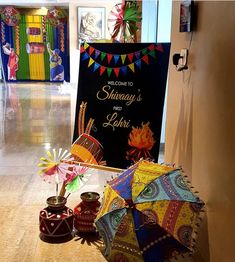 colorful umbrellas and decorations on the floor in front of a sign that reads, welcome to shinaway's for lori