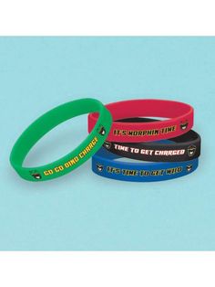 three different colored wristbands with words on them