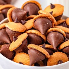 a bowl filled with chocolate covered cookies on top of a table