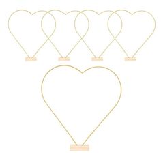 six heart shaped necklaces with tags attached to them