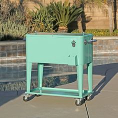 a blue cooler sitting next to a swimming pool