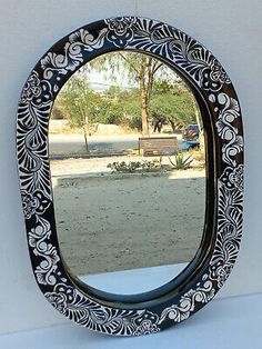 a black and white mirror sitting on top of a table