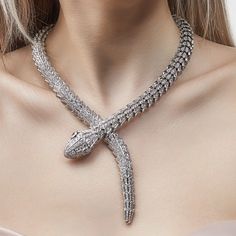 Crafted in 18-karat white gold, this Serpenti necklace is a stunning example of Bulgari's artistry and innovation. The sinuous serpent design is adorned with a mesmerizing display of diamonds that mimic the snake's scales, creating a captivating visual effect. Created in 2013 and featuring over 76 carats of diamonds, this is a Serpenti design to top all others. Details:18k White Gold76.25 Carats Diamonds Total Weight0.80 Carats Pear-Shaped Diamonds, D-Color, VVS Clarity75.45 Carats Pavé-Set Roun Snake Diamond Necklace, Bvlgari Jewelry Serpent, Bvlgari Snake Necklace, Serpenti Bvlgari, Bulgari Necklace, Jungkook Ff, Bulgari Serpenti, Serpent Necklace, Bulgari Jewelry