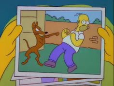 the simpsons is holding up a picture of himself and his dog