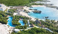 an aerial view of the resort and surrounding area with trees, grass, and water