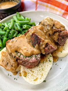 meatloaf with gravy, mashed potatoes and green beans on a plate