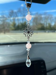 a car dashboard with a flower hanging from it's side