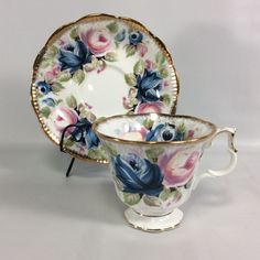 an antique tea cup and saucer decorated with flowers