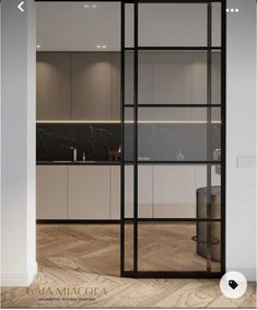 an open glass door leading into a kitchen