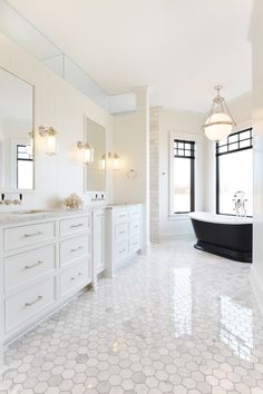 a large bathroom with two sinks and a bathtub