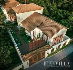 an aerial view of a house in the woods