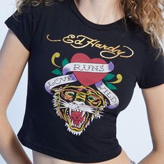 New Ed Hardy Tiger Heart Crop T-Shirt Sz Xl The Tiger Heart T-Shirt From Ed Hardy Makes For A Cool Piece For Your Throwback Look. This Classic Baby Tee Has A Custom Ed Hardy Graphic On The Front And Gets Finished Off With Short Sleeves, A Crew Neckline, And A Cropped Fit. Signed On The Back. Graphic Says "Love Runs Wild" Color: Black, Gold, Red, Yellow, Green, White Condition: New With Tags, Never Been Worn Size: Xl Pit To Pit 19" Length 18" Graphic Tee With Heart Graphic For Streetwear, Grunge Short Sleeve Top With Heart Graphic, Grunge Crew Neck Top With Heart Graphic, Black Grunge Tops With Heart Graphic, Black Grunge Top With Heart Graphic, Black Y2k Top With Heart Graphic, Y2k Black Top With Heart Graphic, Ed Hardy Tiger, Graphic Baby Tee