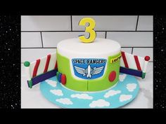 a birthday cake with the number three on it's top and an airplane theme