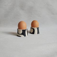 two egg cups sitting on top of each other