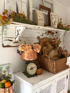 there is a shelf that has many items on it and some flowers in the basket