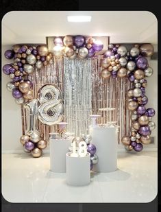 balloons and streamers are set up in front of a backdrop with the letter s