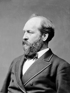 an old black and white photo of a man with a beard wearing a suit jacket