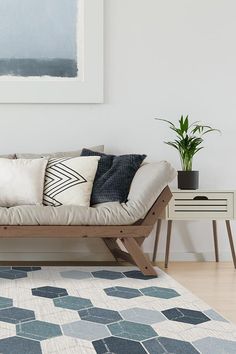 a living room scene with focus on the couch and rug in the foreground,