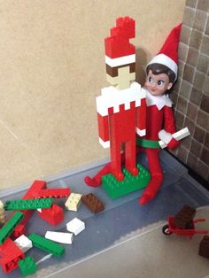 an elf is playing with legos on the floor