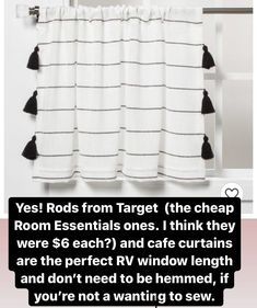 a white curtain with black tassels hanging from it's side and the words room essentials on top