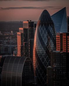 an aerial view of some very tall buildings in the city at sunset or sunrise time