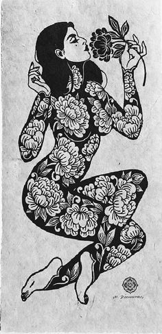 a woman with flowers in her hand is sitting on the ground and holding a flower