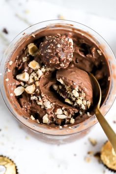 a bowl filled with chocolate and nuts on top of a table